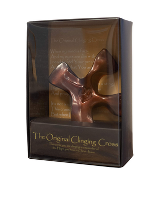 Bronze cross in a decorative box with text
