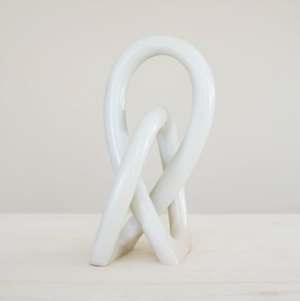 White abstract sculpture on a light gray background