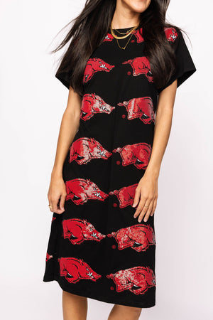 Black dress with red graphic designs worn by a model on a white background