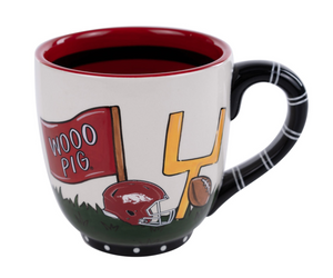 Decorative mug with football-themed design on a white background