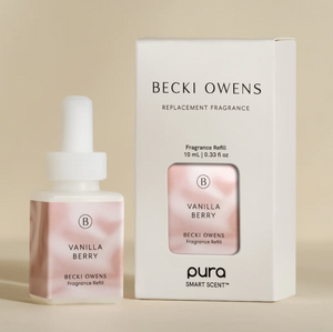 A product image featuring a small bottle of Vanilla Berry fragrance refill next to its packaging box, labeled 'BECKI OWENS Replacement Fragrance'.