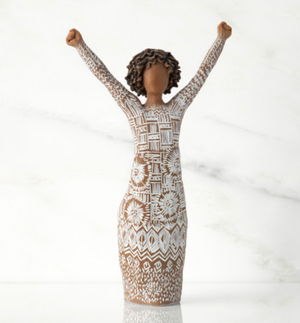 Statue of a woman in a patterned dress with raised arms on a white background