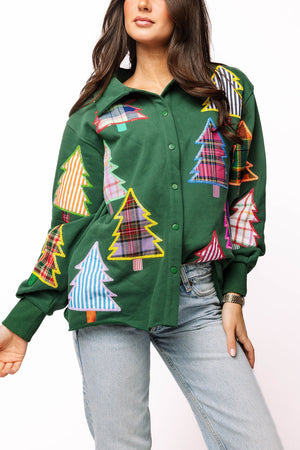 Green shirt with colorful tree patterns worn by a model on a white background